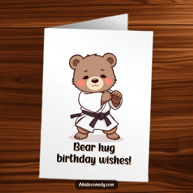 Funny Free Printable Birthday Card featuring a determined bear cub in a gi practicing a gentle Aikido roll, ready to celebrate.
